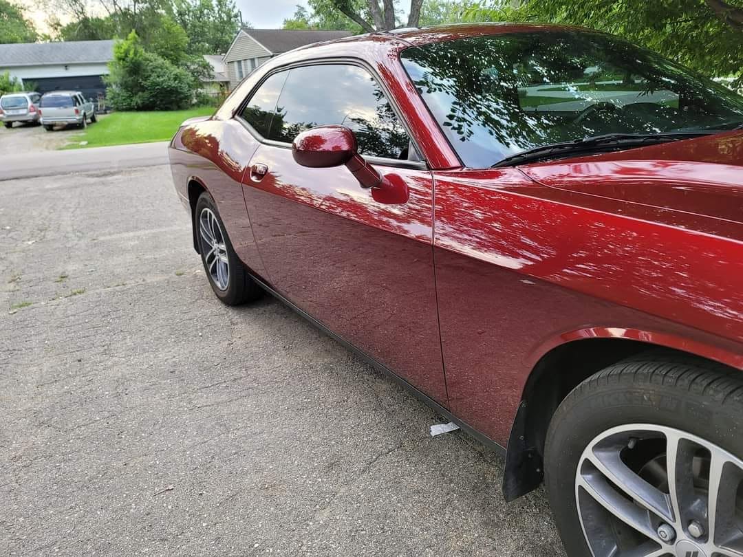 Freshly detailed red Dodge Challenger with deep glossy finish by Lakes Detailing